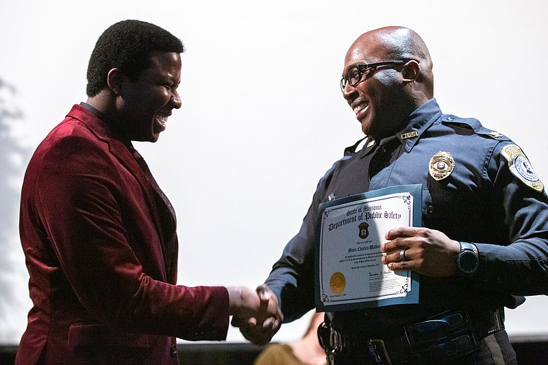 Max Walker and Lincoln University Police Chief Gary Hill laugh and shake hands as Walker graduates from the LU Law Enforcement Training Academy on Thursday at Thomas Pawley Theater in Jefferson City. (Ethan Weston/News Tribune)