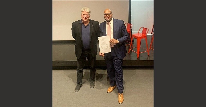 Peter MacKeith (left), dean of the Fay Jones School of Architecture and Design, makes a presentation to Ryan Watley, chief executive officer of Go Forward Pine Bluff. 
(Special to The Commercial)