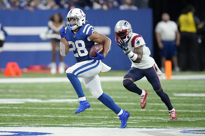 Indianapolis Colts running back Jonathan Taylor (left) runs for a 67-yard touchdown during the second half Saturday against the New England Patriots in Indianapolis. Taylor ran for 170 yards in a 27-17 victory.
(AP/AJ Mast)