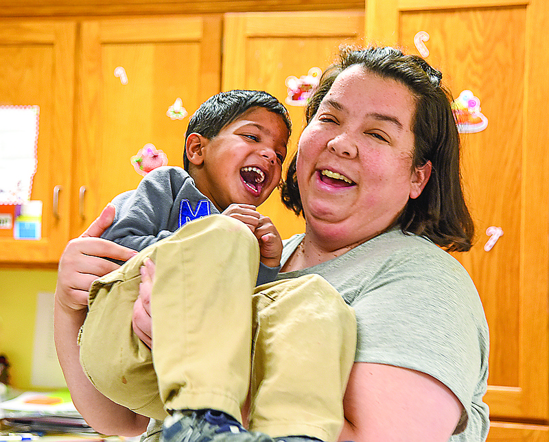 Much to the delight of Sayan Nieland, Scribes room leader Katie Winn swung him out as she picked him up recently at the Special Learning Center in Jefferson City.