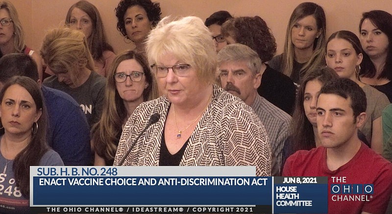 In this June 8, 2021, photo provided by The Ohio Channel, Dr. Sherri Tenpenny speaks at a Ohio House Health Committee in Columbus. The Cleveland-based osteopathic doctor testified that covid-19 vaccines cause magnetism. “They can put a key on their forehead; it sticks,” Tenpenny said. (The Ohio Channel via AP)