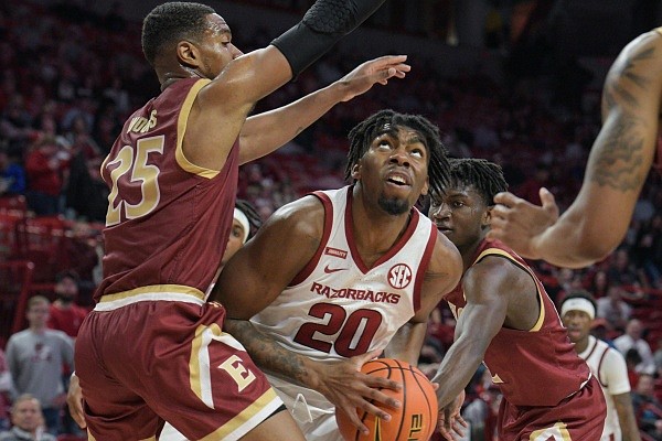 Kamani Johnson of Arkansas prepares to shoot on Tuesday, Dec. 21, 2021, against Hunter Woods of Elon during the second half of the Razorbacks’ 81-55 win at Bud Walton Arena in Fayetteville. Kamani Johnson of Arkansas prepares to shoot on Tuesday, Dec. 21, 2021, against Hunter Woods of Elon during the second half of the Razorbacks’ 81-55 win at Bud Walton Arena in Fayetteville.