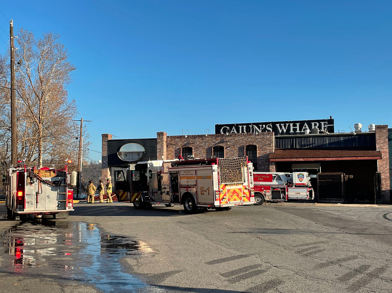Firefighters work at the scene of a fire in the building that used to house Cajun's Wharf on Tuesday morning in Little Rock. (Arkansas Democrat-Gazette/Tommy Metthe)