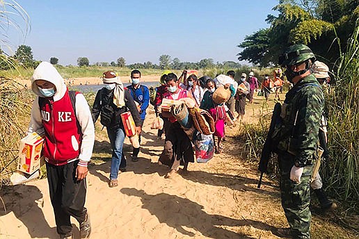 Thai soldiers receive Burmese villagers arriving in Mae Sot, Tak province, northern Thailand, earlier this month after fleeing clashes between Burmese troops and an ethnic Karen rebel group.
(AP/Thailand Ministry of Defense)