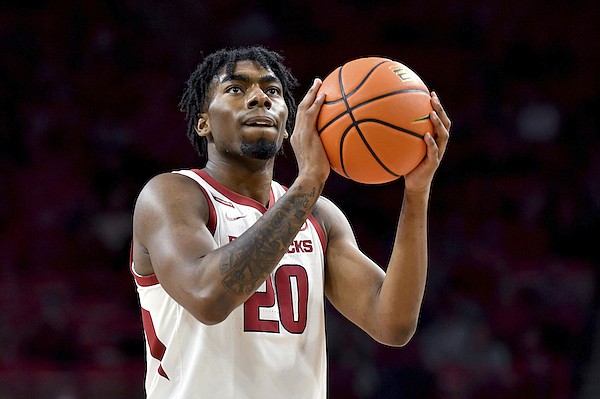 Arkansas forward Kamani Johnson (20) shoots a free throw against Elon during the first half of an NCAA college basketball game Tuesday, Dec. 21, 2021, in Fayetteville. (AP Photo/Michael Woods)