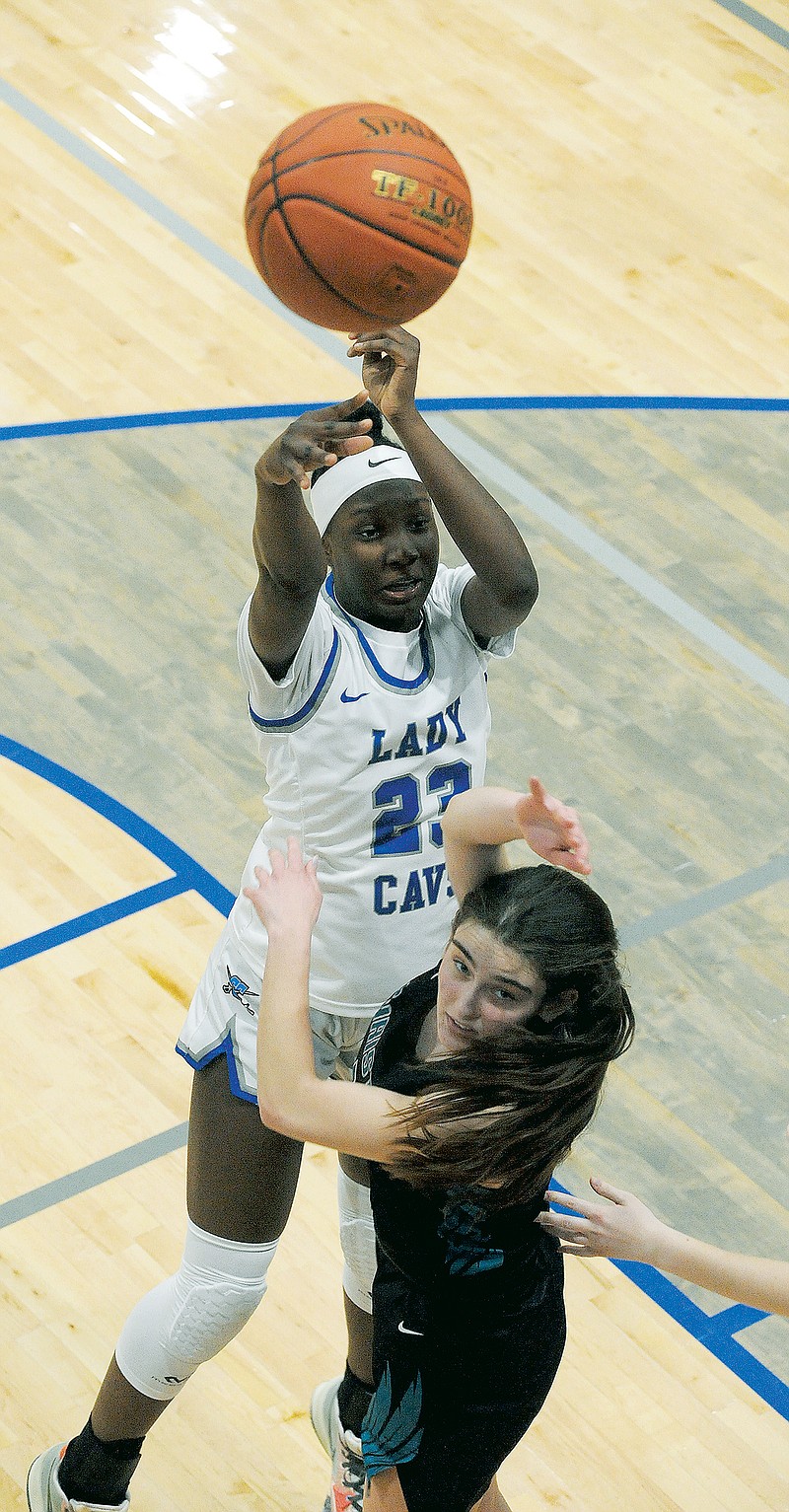Capital City's Jada Anderson shoots over the top of O'Fallon Christian's Nicole Schwepker during a game earlier this month at Capital City High School. (Shaun Zimmerman/News Tribune)