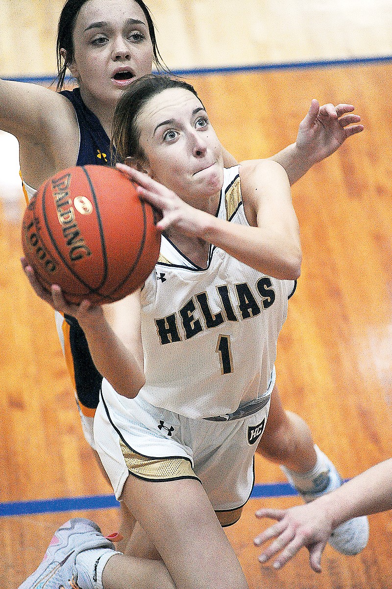 Ava Morris of Helias drives for a layup during a game against Camdenton earlier this season at Rackers Fieldhouse. (Shaun Zimmerman/News Tribune)