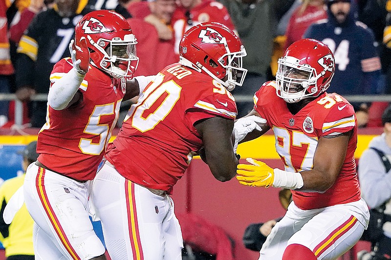 Chiefs defensive tackle Jarran Reed (center) is congratulated by teammates Willie Gay Jr. (right) and Alex Okafor after recovering a fumble by Steelers quarterback Ben Roethlisberger during the second half of Sunday’s game at Arrowhead Stadium. (Associated Press)