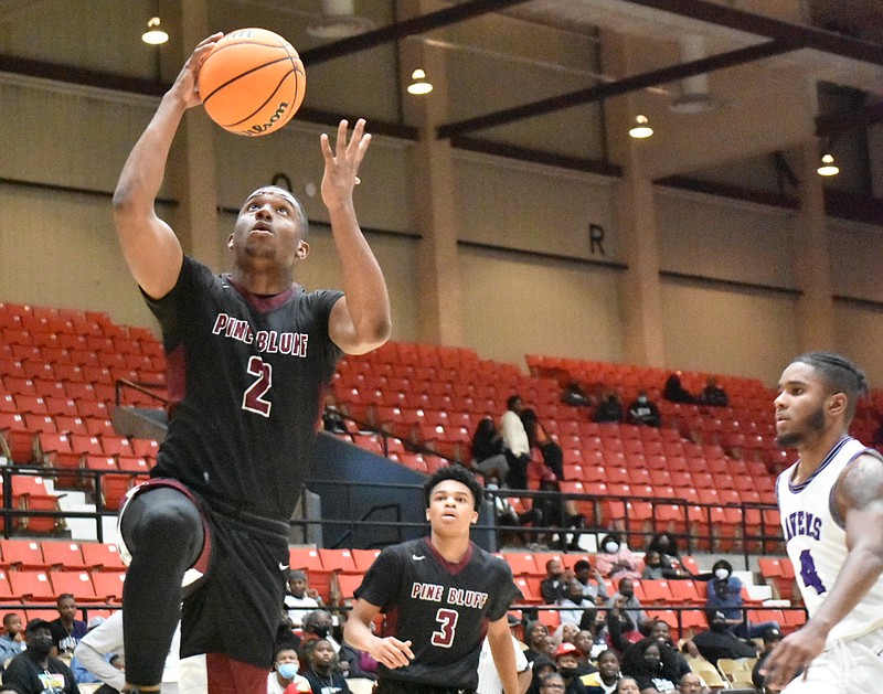 X'Zaevion Barnett of Pine Bluff drives to the basket as teammate Troy'reon Ramos and Ja'Lynn Lawrence of Antioch (Tenn.) Cane Ridge look on in the second quarter late Monday, Dec. 27, 2021, at the Pine Bluff Convention Center. (Pine Bluff Commercial/I.C. Murrell)