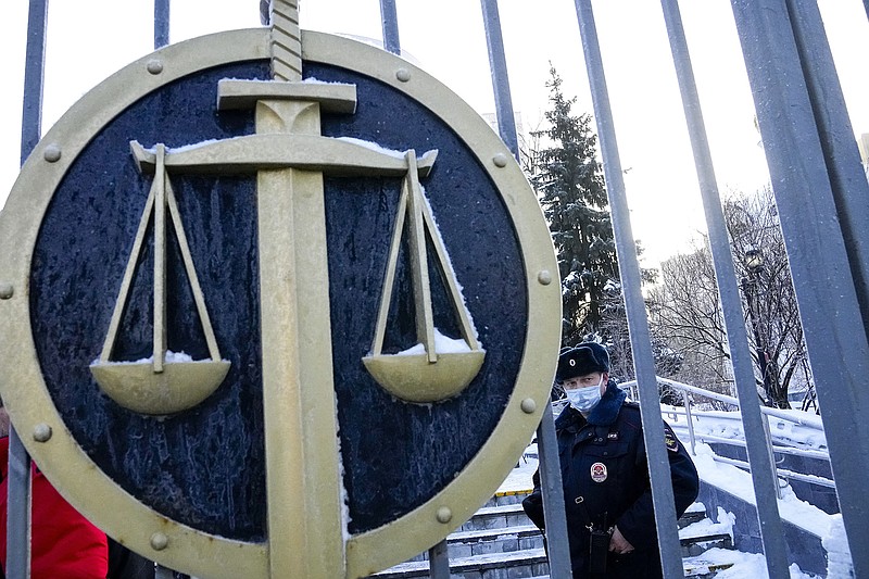 A police officer on Wednesday guards an entrance to the Moscow City Court as supporters of the Memorial Human Rights Center gather to protest the ruling shutting down the prominent organization under a “foreign agents” law.
(AP/Alexander Zemlianichenko)