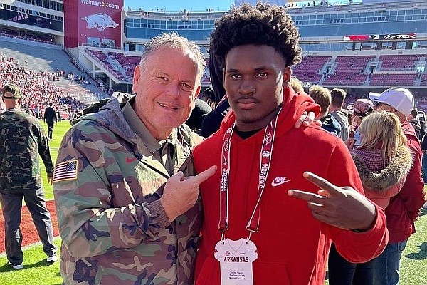 2023 DB Dallas Young visits with Arkansas coach Sam Pittman before the Mississippi State game.