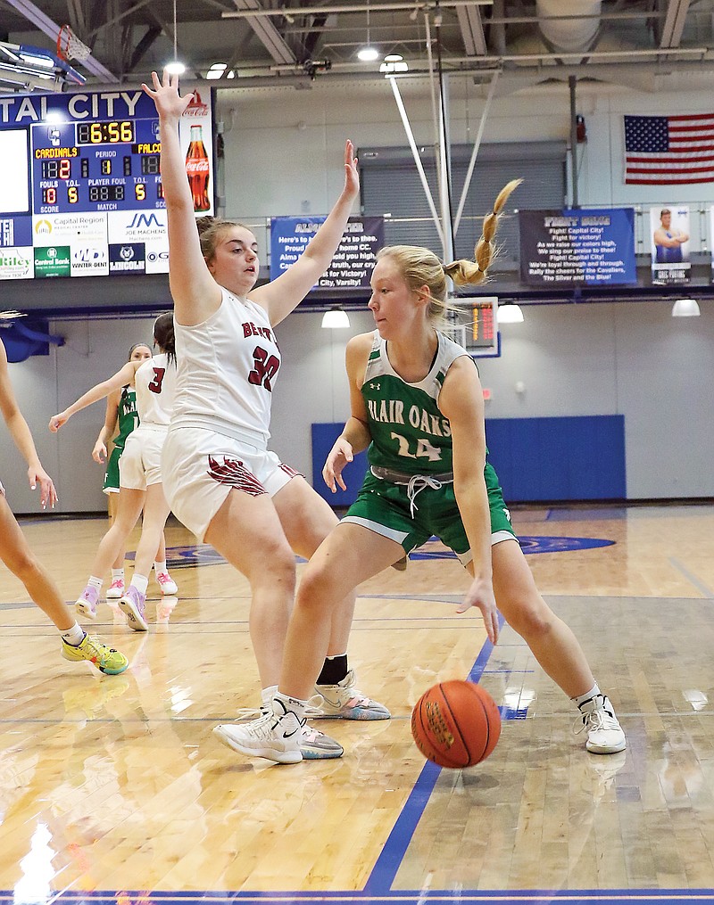 Grace Boessen of Blair Oaks works her way past St. Joseph Benton’s Lauren Burright during Tuesday’s game in the Holiday Hoops Tournament at Capital City High School. (Jason Strickland/News Tribune)