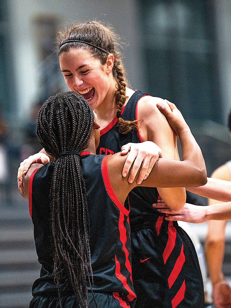 Jefferson City’s Hannah Linthacum embraces teammate Emmarie Graham after Linthacum made a layup during Tuesday’s game against Vashon in the Jefferson Bank Holiday Hoops Tournament at Capital City High School. (Ethan Weston/News Tribune)