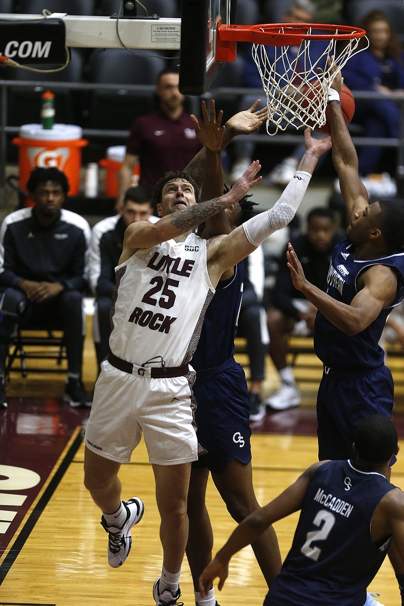 UALR’s Nikola Maric (25) puts up a shot over Georgia Southern defenders during the second half of the Trojans’ 78-66 victory Thursday at the Jack Stephens Center in Little Rock. Maric finished with 25 points and eight rebounds. More photos at arkansasonline.com/1231ualr/
(Arkansas Democrat-Gazette/Thomas Metthe)