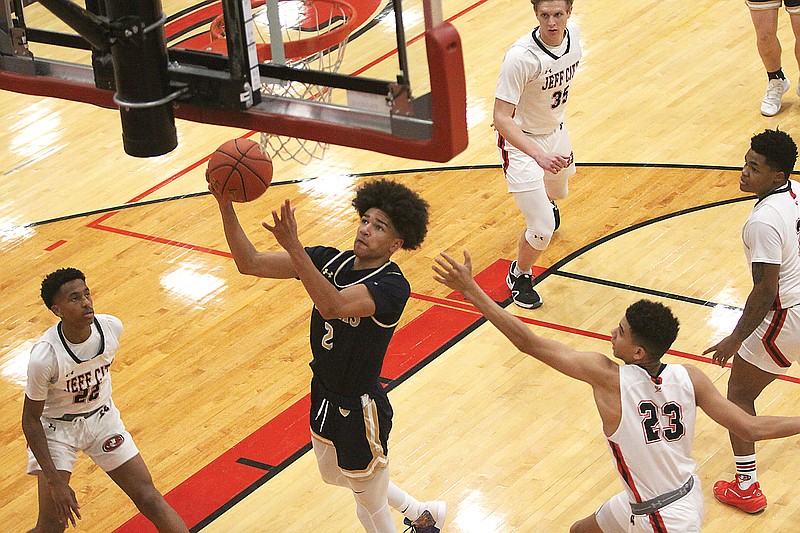 Desmond White of Helias drives the lane for a layup during the first half of Wednesday’s third-place game against Jefferson City in the Joe Machens Great 8 Classic at Fleming Fieldhouse. (Greg Jackson/News Tribune)