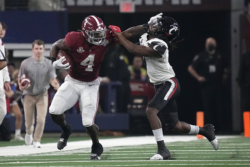 Alabama running back Brian Robinson fends off Cincinnati cornerback Arquon Bush during the first half of the Cotton Bowl on Friday in Arlington, Texas. Robinson ran for 204 yards to help propel the Crimson Tide to a 27-6 victory.
(AP/Jeffrey McWhorter)