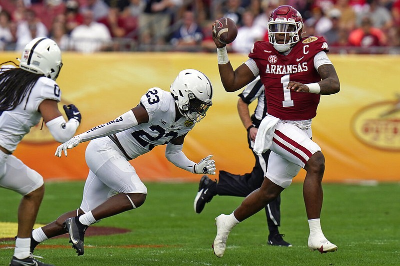 Arkansas quarterback KJ Jefferson (1) eludes Penn State linebacker Curtis Jacobs (23) during the first half of the Outback Bowl in Tampa, Fla., on Saturday, Jan. 1, 2022. (AP/Chris O'Meara)