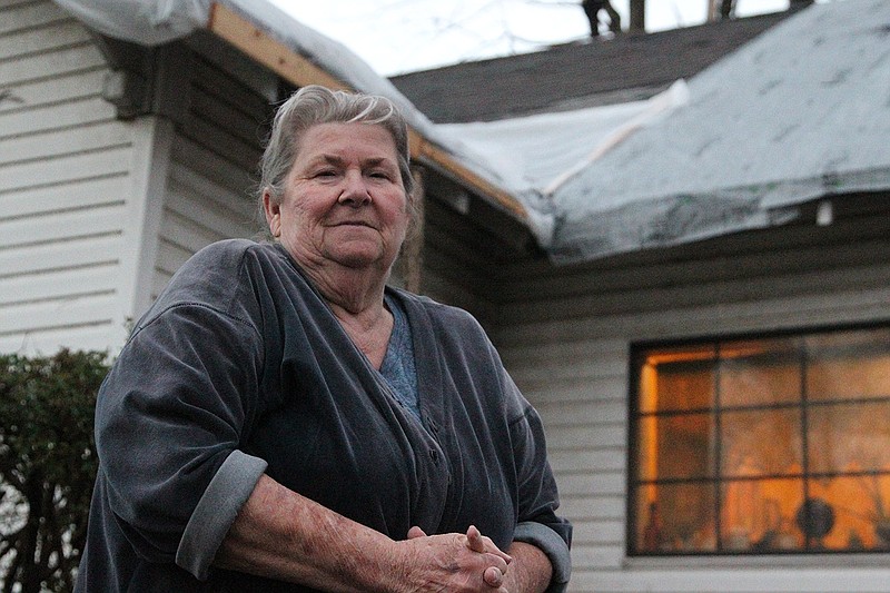 Joann Carmichael stands outside her home in Leachville. While her house received minimal damage from a tornado that passed through the area earlier this month, reconstruction efforts were progressing slowly, she said. As of Wednesday, she was waiting for a claims adjuster to inspect her property.
(ArkansasDemocrat-Gazette/Will Langhorne)