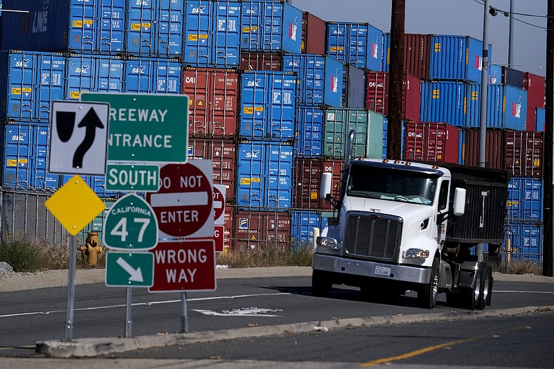 FILE - ,Cargo containers sit stacked at the Port of Los Angeles, Wednesday Oct. 20, 2021 in San Pedro, Calif. California Gov. The Los Angeles-Long Beach port complex will begin fining shipping companies if they let cargo containers stack up as the nation's busiest twin harbors deal with an unprecedented backlog of vessels. The Los Angeles and Long Beach harbor commissions voted Friday, Oct. 29, 2021 to implement a 90-day ?container excess dwell fee? that sets time limits on how long containers can stay at marine terminals. (AP Photo/Ringo H.W. Chiu)