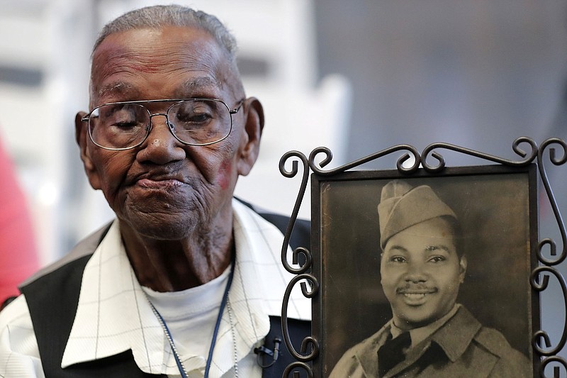 Lawrence Brooks holds his Army portrait that was taken in 1943 during a celebration of his 110th birthday on Sept. 12, 2019, at the National World War II Museum in New Orleans.
(AP/Gerald Herbert)