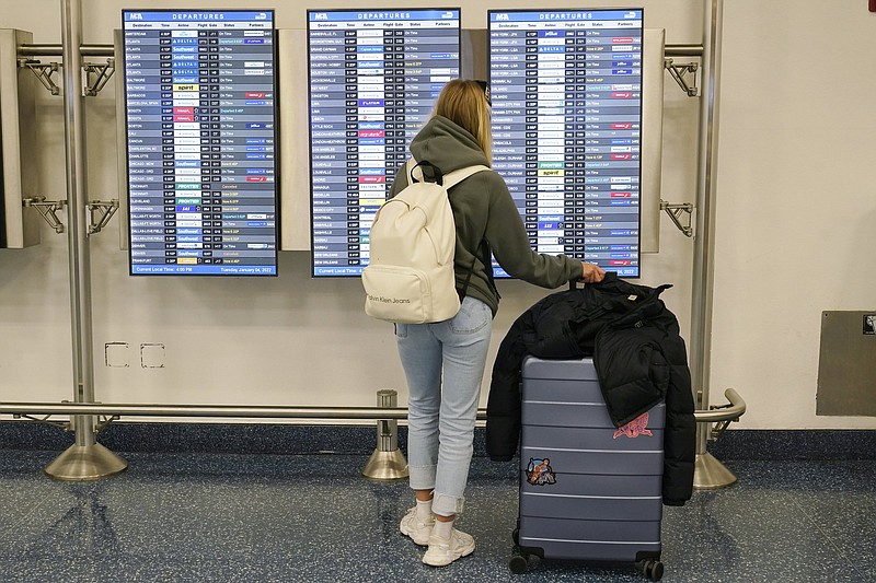 A passenger checks the airline departure board at Miami International Airport on Tuesday.
(AP/Marta Lavandier)