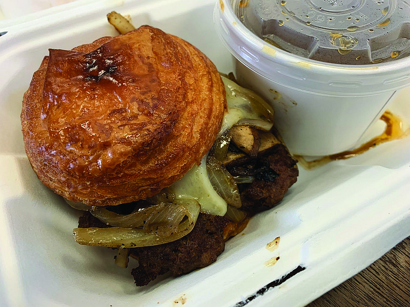You'll still have to visit the food truck for The Croissanterie's popular burger-on-a-croissant, even after owner Wendy Schay opens a brick-and-mortar storefront on Cantrell Road, with a February target. (Democrat-Gazette file photo/Eric E. Harrison)