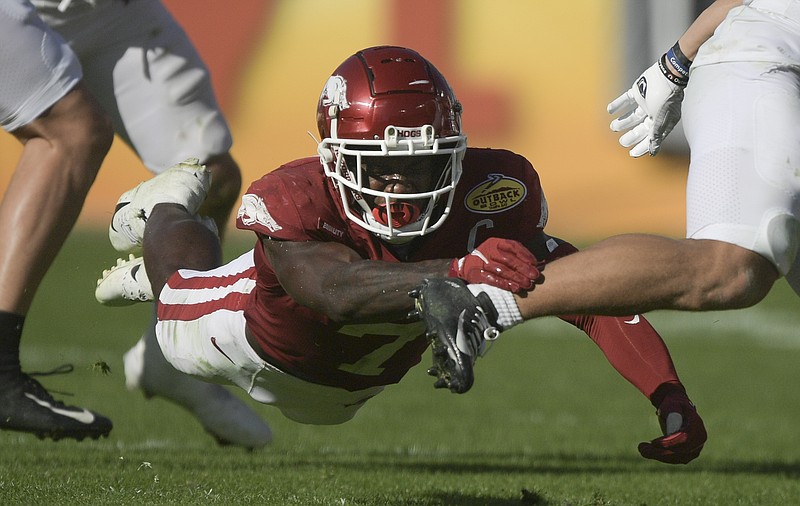 Arkansas safety Joe Foucha dives to make a tackle during the Razorbacks' 24-10 win over Penn State in the Outback Bowl on Saturday, Jan. 1, 2022, in Tampa, Fla.