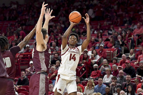 Arkansas guard Jaxson Robinson (14) shoots over an Arkansas-Little Rock defender during the first half of an NCAA college basketball game Saturday, Dec. 4, 2021, in Fayetteville. (AP Photo/Michael Woods)