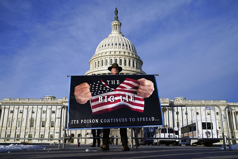 A protester holds his sign at the Capitol in Washington on Thursday, Jan. 6, 2022. "The Big Lie" refers to the claim by former President Donald Trump that the 2020 presidential election was stolen. The claim inspired Trump supporters to rally at the Capitol on Jan. 6, 2021, as the votes were being certified. (AP/Evan Vucci)