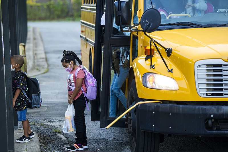 Students get off a Little Rock School District bus in this Aug. 16, 2021, file photo. (Arkansas Democrat-Gazette/Stephen Swofford)