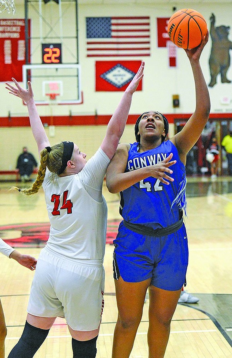 Conway's Savannah Scott (42) shoots as Northside's Tracey Bershers (24) defends on Friday, Feb. 12, 2021 in Gayle Kaundart-Grizzly Fieldhouse in Fort Smith. Conway won the game 69-56. (Special to NWA Democrat Gazette/Brian Sanderford)