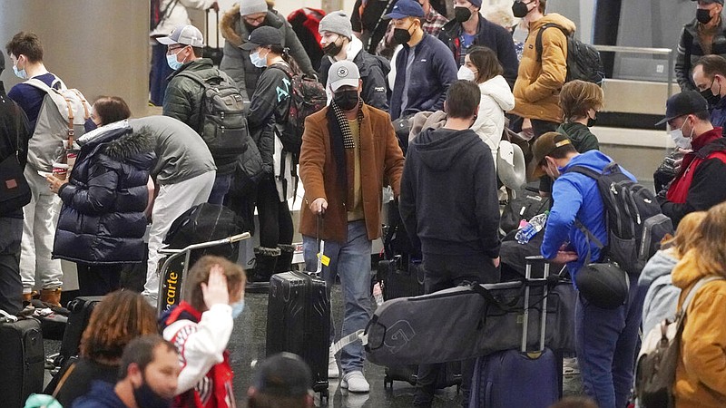 Travelers pass through Salt Lake City International Airport on Wednesday, Jan. 5, 2022. (AP/Rick Bowmer)