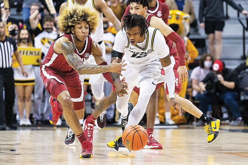 Missouri’s DaJuan Gordon and Alabama’s JD Davison battle for a loose ball during the second half of Saturday afternoon’s game at Mizzou Arena. (Associated Press)