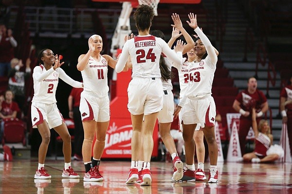 Arkansas players high five on Sunday, Jan. 9, 2022 during a basketball game at Bud Walton Arena in Fayetteville. Check out nwaonline.com/220110Daily/ for the photo gallery.