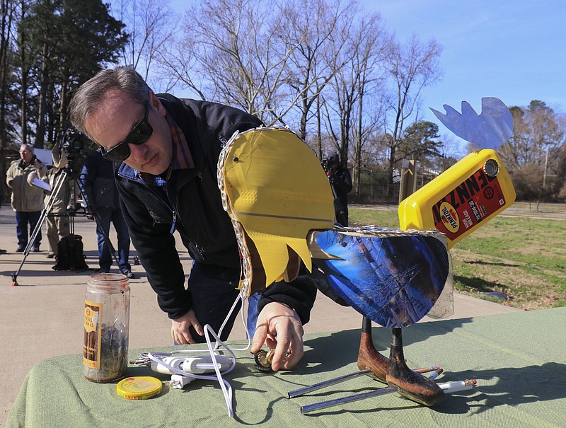 Leland Couch, then the design manager for the Little Rock Parks and Recreation Department, sets up a sculpture before a press conference to announce the Found Objects sculpture contest in this February 2019 file photo. Couch made the sculpture from items found in city parks, and it was meant to promote the 10th annual Little Rock Sustainability Summit, which featured artwork made from litter found in city parks and waterways. (Arkansas Democrat-Gazette/Staton Breidenthal)