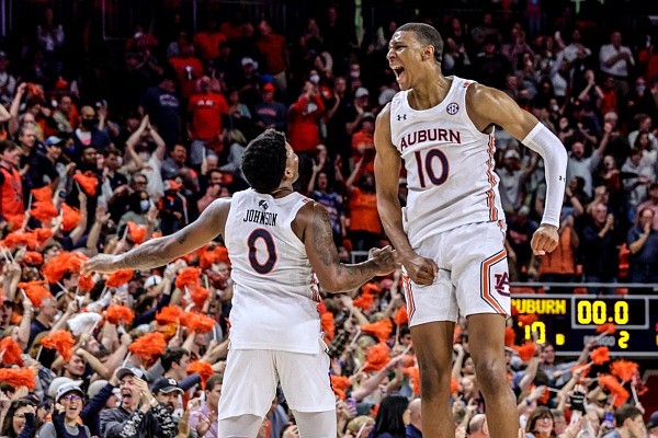 Auburn guard K.D. Johnson (0) and forward Jabari Smith (10) celebrate after defeating LSU during the second half of an NCAA college basketball game Wednesday, Dec. 29, 2021, in Auburn, Ala. (AP Photo/Butch Dill)