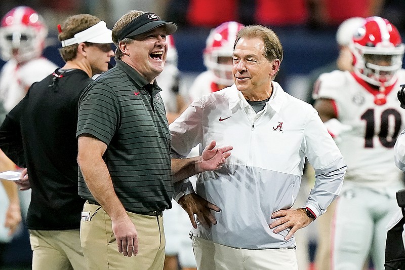 In this Dec. 4, 2021, file photo, Georgia coach Kirby Smart shares a laugh with Alabama coach Nick Saban before the start of the SEC Conference Championship Game in Atlanta. (Associated Press)