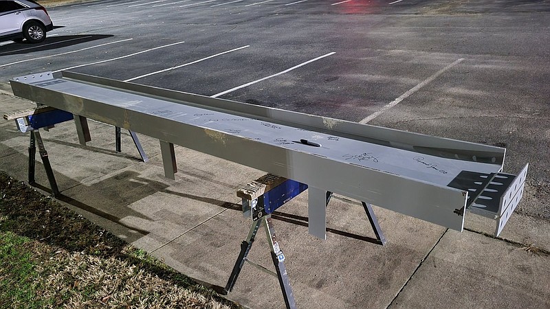 An I-beam rests outside the White Hall School District administration building during Tuesday’s board meeting. Board and faculty members signed the beam, which will be used to “top out” the fine arts building at the high school during a ceremony today. 
(Pine Bluff Commercial/I.C. Murrell)