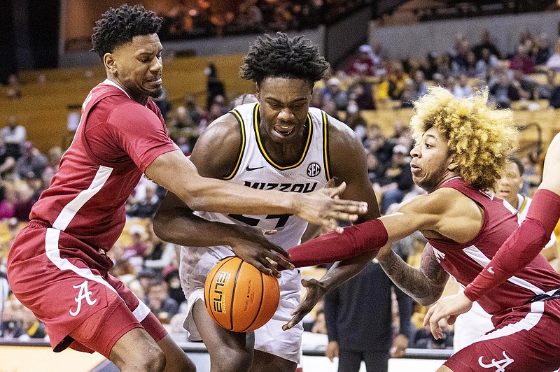 Missouri’s Kobe Brown (center) has the ball knocked away by Alabama’s Noah Burley (left) and JD Davison during last Saturday’s game at Mizzou Arena. (Associated Press)