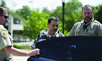 Mauricio Torres is escorted out of the Benton County Courthouse Annex in Bentonville in this June 21, 2019, file photo. (Charlie Kaijo/NWA Democrat-Gazette)