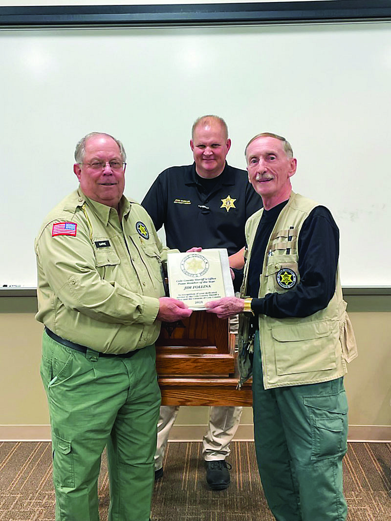 Jim Follina, right, receives the Volunteer of the Year plaque from Posse Advisor Greg Gaffke. Looking on is Cole County Sheriff John Wheeler. (Submitted photo)