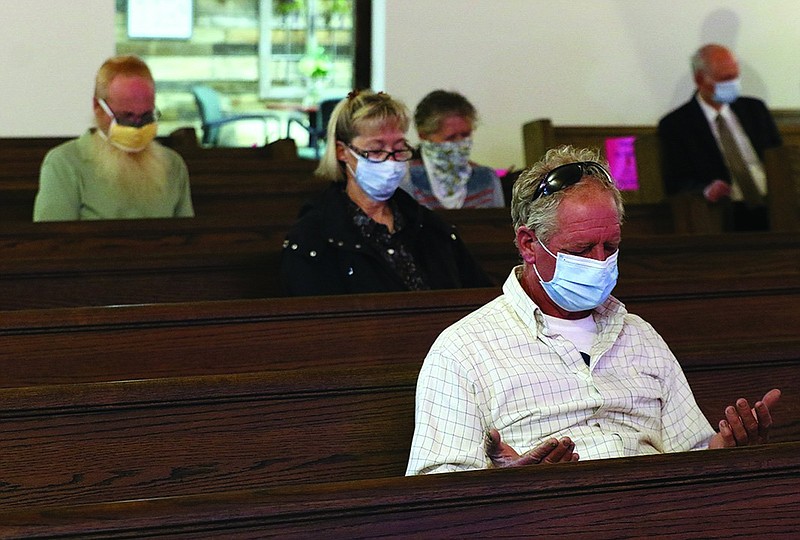 Members of Crossroads New Baptist Church in Little Rock wore masks and social distanced as they gathered to worship early in the covid-19 pandemic. With the omicron variant spreading, some Arkansas congregations are weighing whether to scale back activities until the latest wave passes.
(Arkansas Democrat-Gazette/Thomas Metthe)