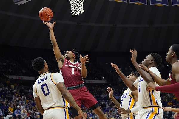 Arkansas guard JD Notae (1) goes to the basket over LSU guard Brandon Murray (0) in the first half of an NCAA college basketball game in Baton Rouge, La., Saturday, Jan. 15, 2022. (AP Photo/Gerald Herbert)