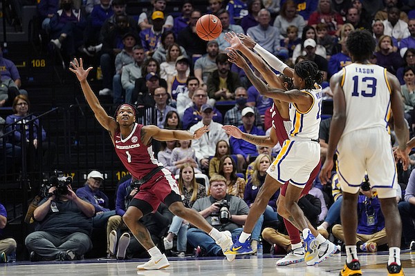Arkansas guard JD Notae (1) moves to catch the ball as LSU forward Tari Eason, right ballets for control in the second half of an NCAA college basketball game in Baton Rouge, La., Saturday, Jan. 15, 2022. Arkansas won 65-58. (AP Photo/Rita Harper)