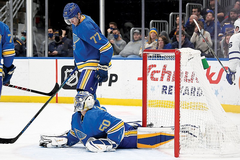 Blues defenseman Niko Mikkola looks down at goaltender Jordan Binnington after the Maple Leafs scored a go-ahead goal in the third period Saturday night in St. Louis. (Associated Press)