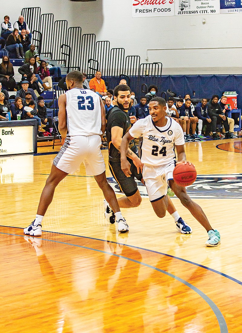 Chuck Wilson drives around a pick set by Lincoln teammate Josh Wallace during Saturday’s game against Central Oklahoma at Jason Gym. (Ken Barnes/News Tribune)