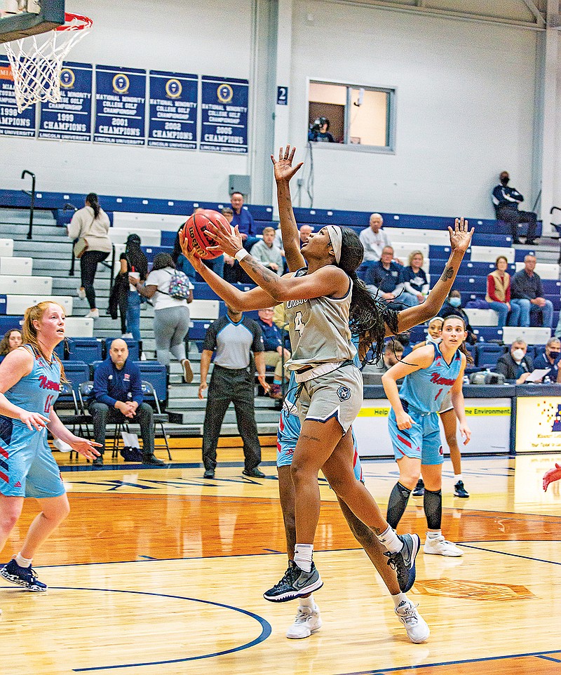 Lincoln’s Imani Jones drives to the basket for a layup during Thursday’s game against Newman at Jason Gym. (Ken Barnes/News Tribune)