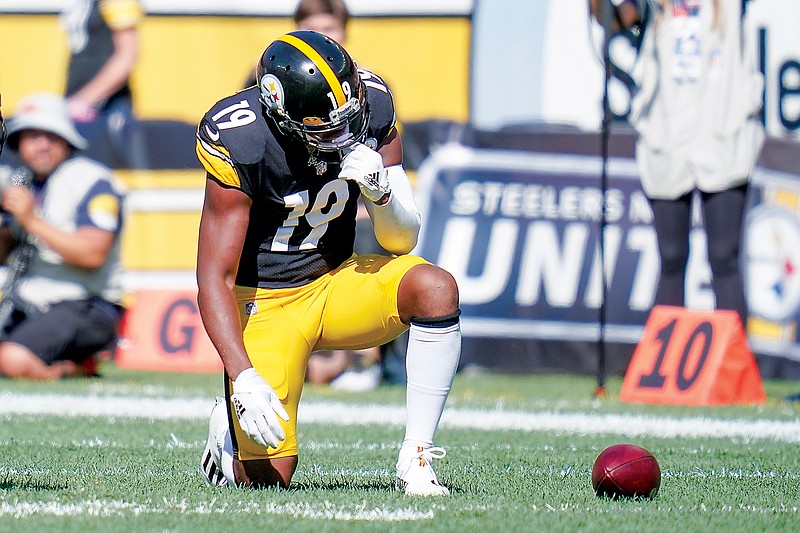 In this Oct, 10, 2021, file photo, Steelers wide receiver JuJu Smith-Schuster takes a knee after being injured during a game against the Broncos in Pittsburgh. (Associated Press)