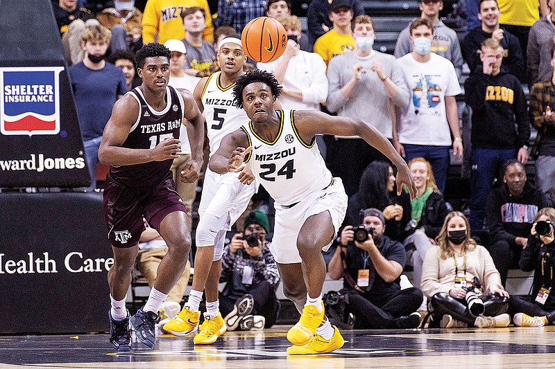 Kobe Brown of Missouri chases down a loose ball in front of Texas A&M’s Henry Coleman III during the second half of Saturday afternoon’s game at Mizzou Arena. (Associated Press)