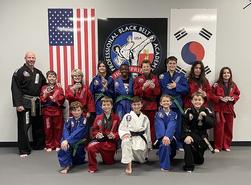 Professional Black Belt Academy of Hot Springs students competed at Winter Nationals in Plano, Texas. Students included, front row, from right, Peyton Larrimer, Layla Short, Tristan Floyd, Parker Larrimer, Napoleon Evans, back row, True Love, Max Love, Liam Wisener, Lucas Whisenhunt, Carson Haynie, Briana Harmon, Black Gilbert, Jesse Stinson and owner and chief instructor Fred Green. - Submitted photo